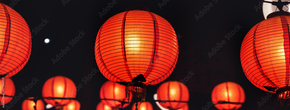 Beautiful round red lantern hanging on old traditional street, concept of Chinese lunar new year fes