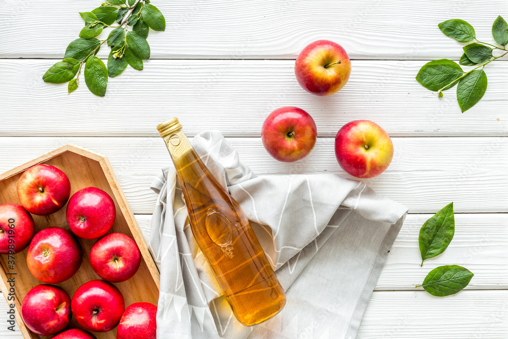 Top view of apple cider or vinegar - bottle with ripe fruits and leaves