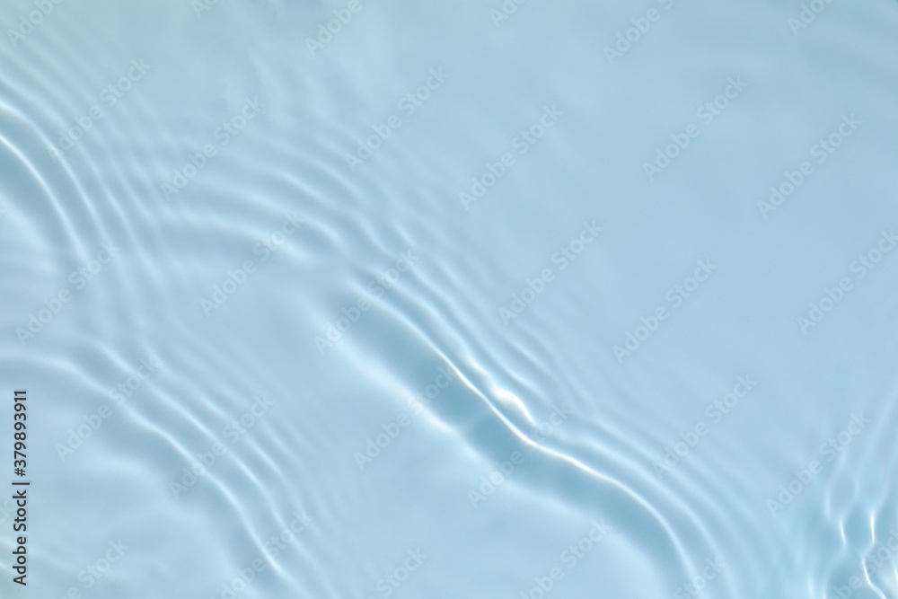 de-focused. Blurred transparent blue colored clear calm water surface texture with splashes and bubb