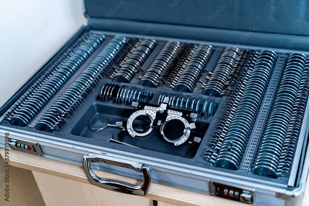 A trial frame with set of corrective lenses. Test vision equipment. Ophthalmology tool box.