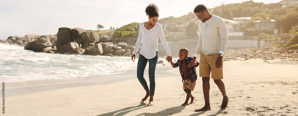 African family on beach walk