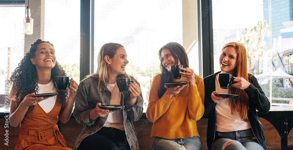 Group of friends having coffee together at a cafe