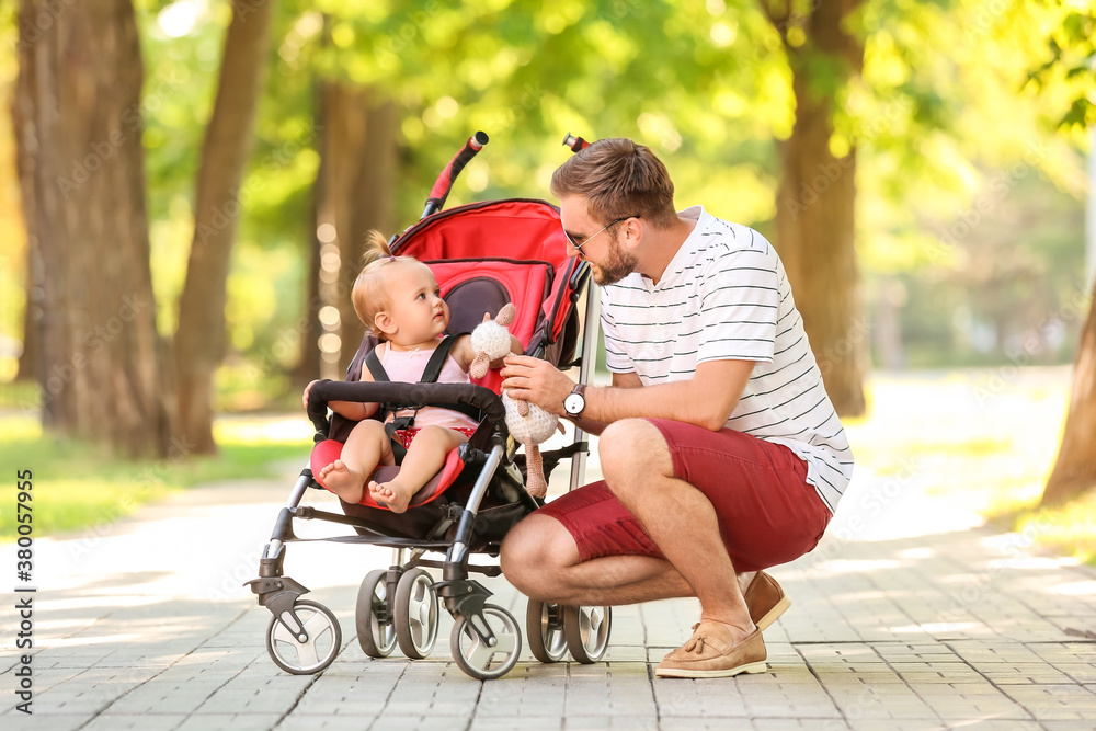 Man and his cute baby in stroller outdoors