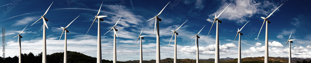 Renewable energy and wind turbines. Wind mills farm and sunset landscape.