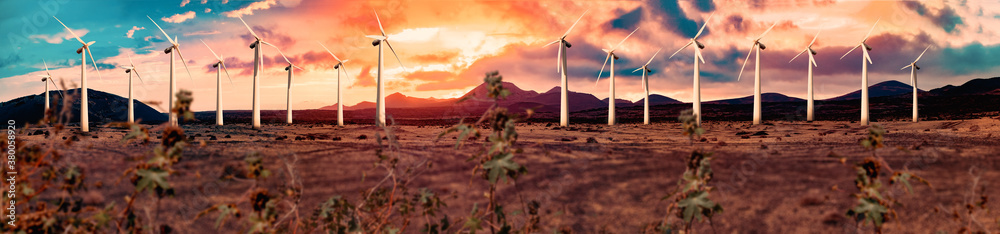 Renewable energy and wind turbines. Wind mills farm and sunset landscape.