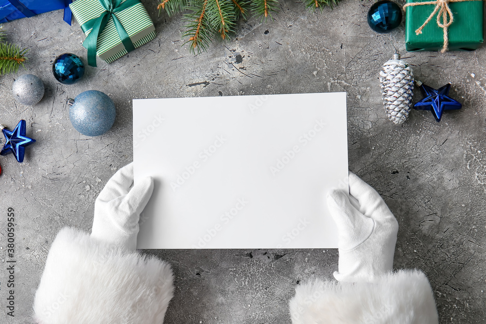 Santa Claus with blank paper sheet at table, top view