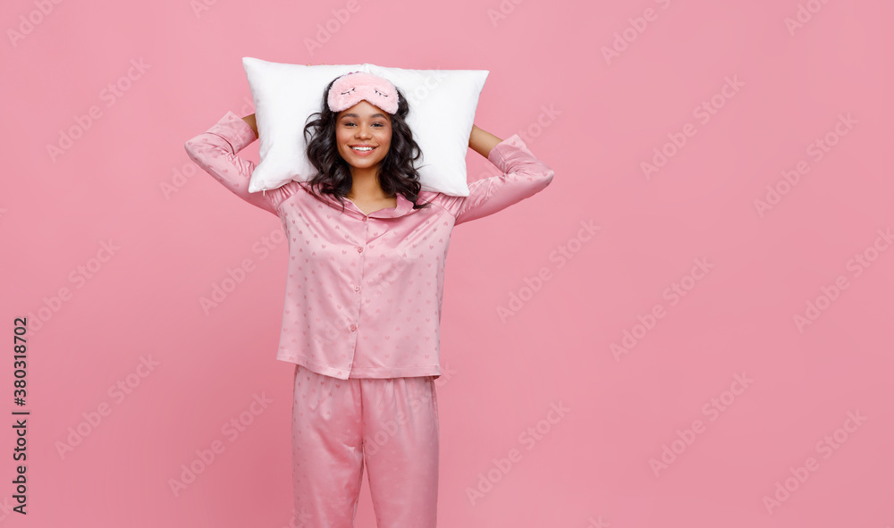 Optimistic young woman lying on the pillow.