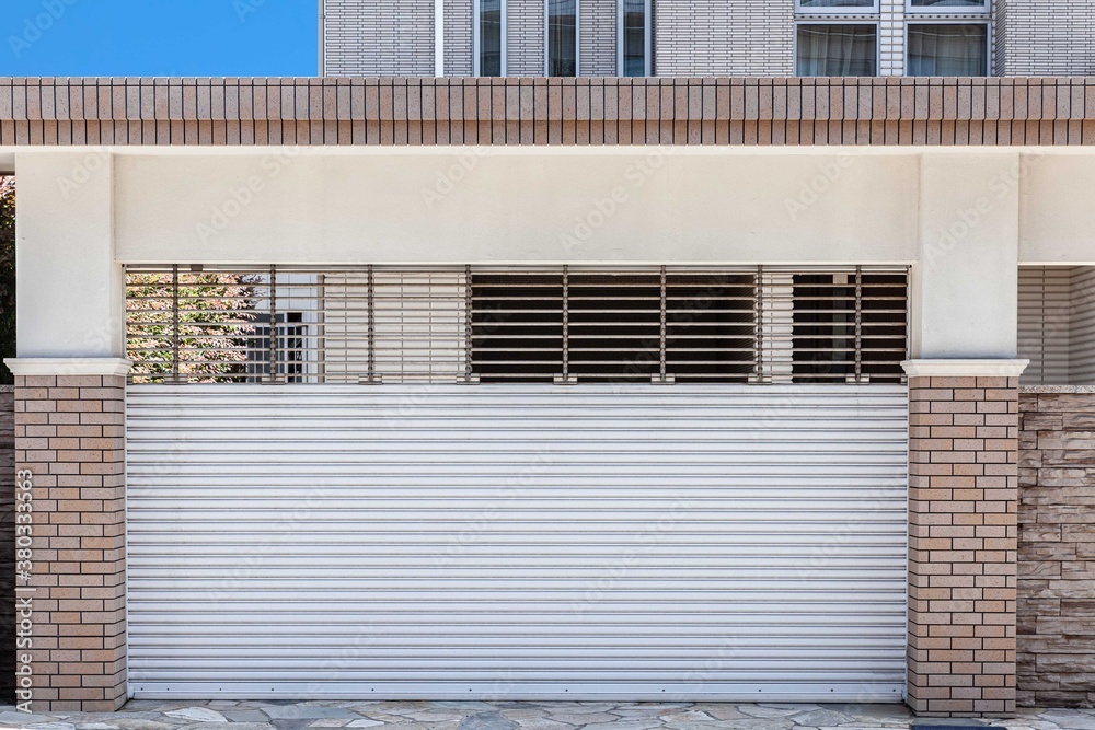 Automatic white roller shutter doors on the ground floor of the house