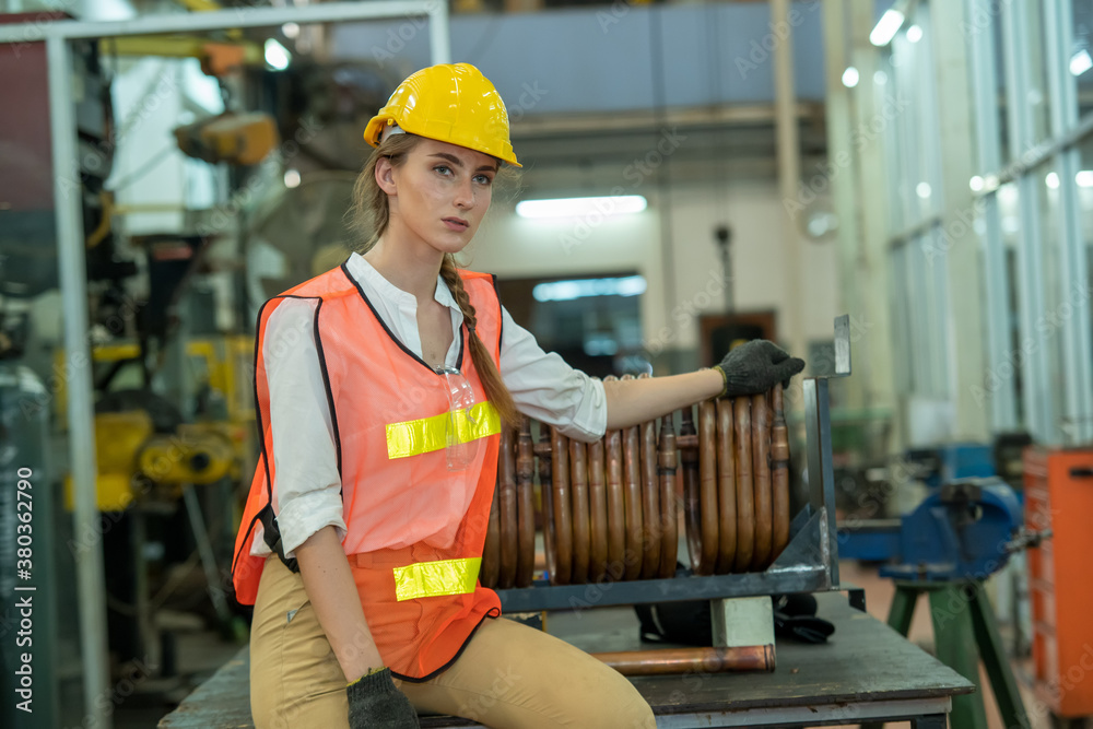 Portrait of industry maintenance engineer worker standing at machine area in factory.