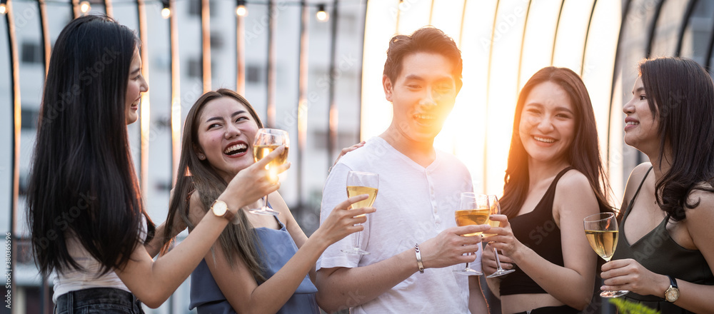 Group of Asian young man and woman holding wine glass and enjoy party.