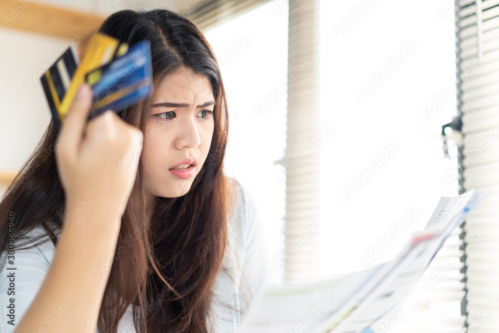 Asian young woman being stressed about her credit card debt problems.