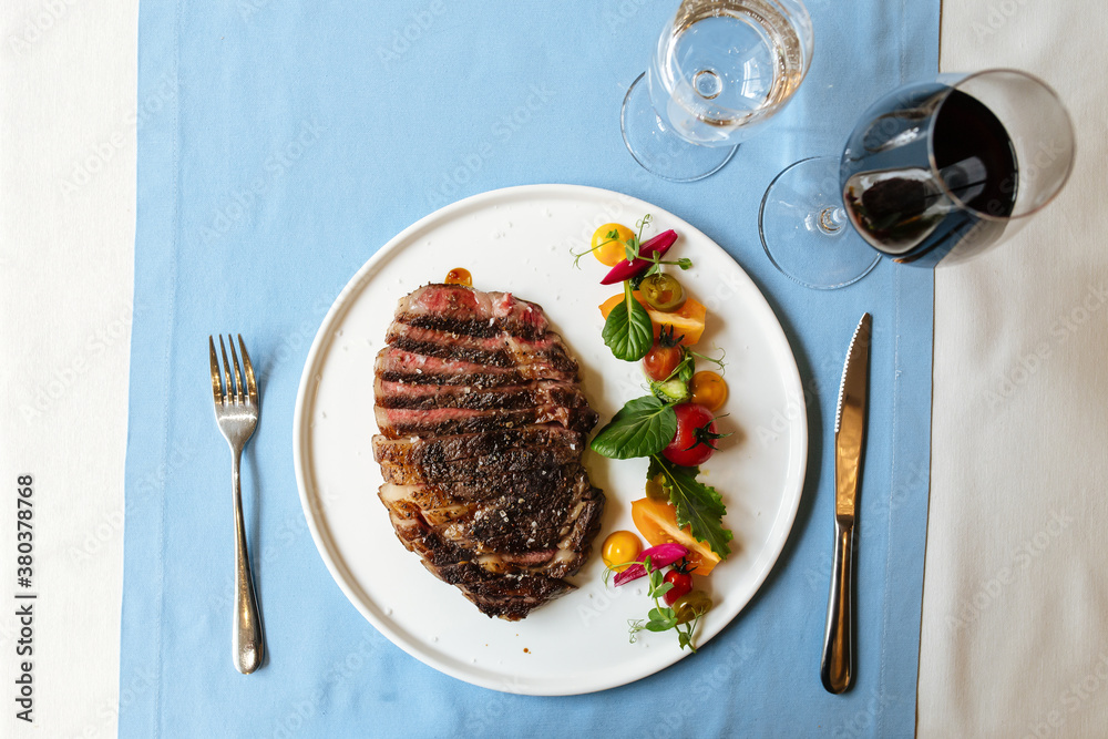 Ribeye beef steak with fresh vegetable salad