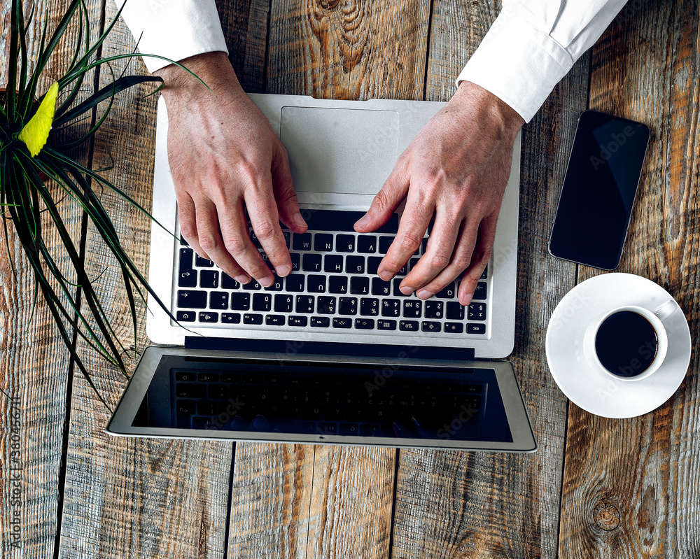 Working place for man with notebook on wooden table