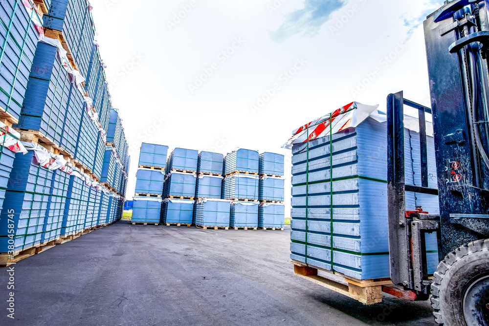 Auto loader with concrete blocks outside factory