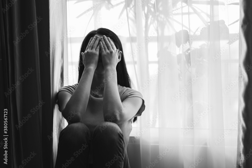  woman sit Depression Standing by window and anxiety Copy space. 
