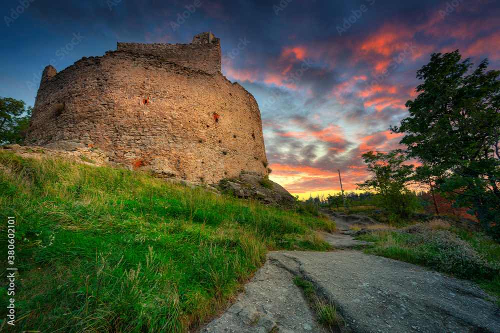 Ruins of Chojnik Castle in Karkonosze mountains at sunset. Poland