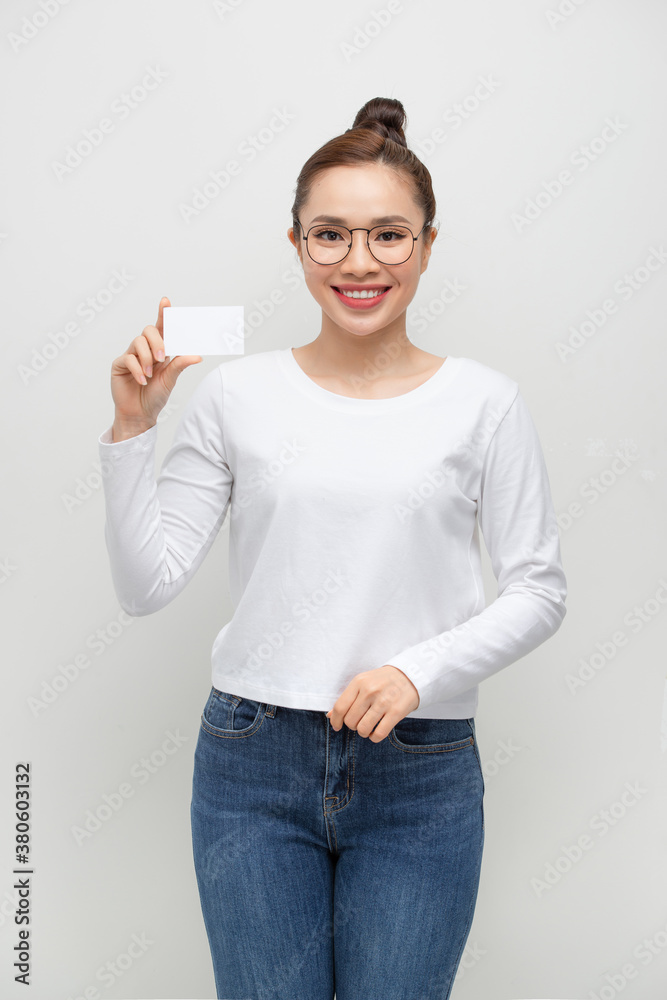 Young smiling woman show blank card. Girl portrait isolated on white background.