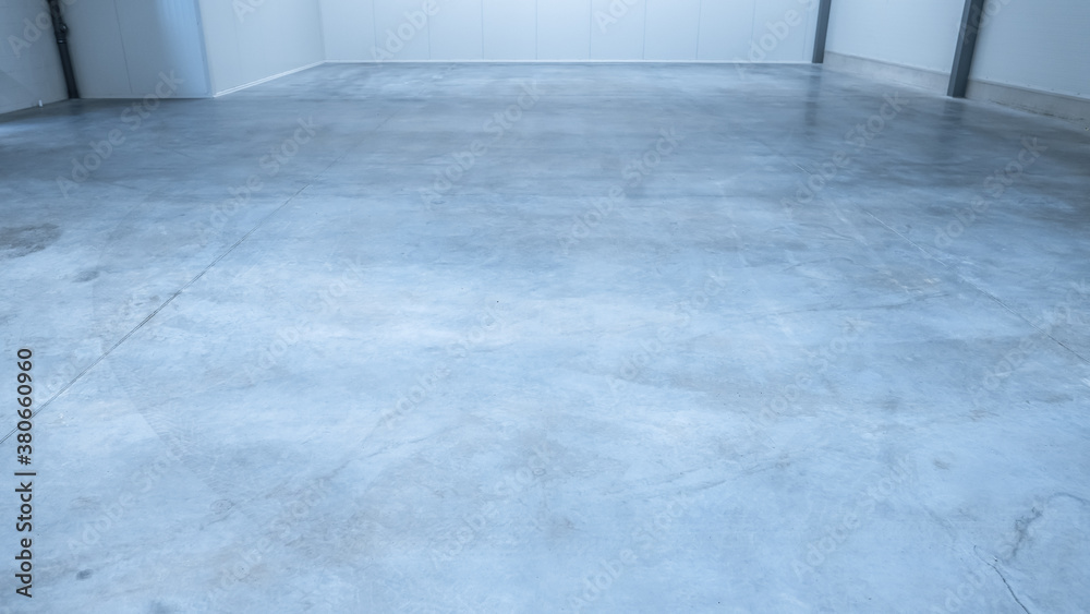 Shot of a Gray Polished Concrete Floor of Lit Empty Warehouse with White Walls. Great Room for Small