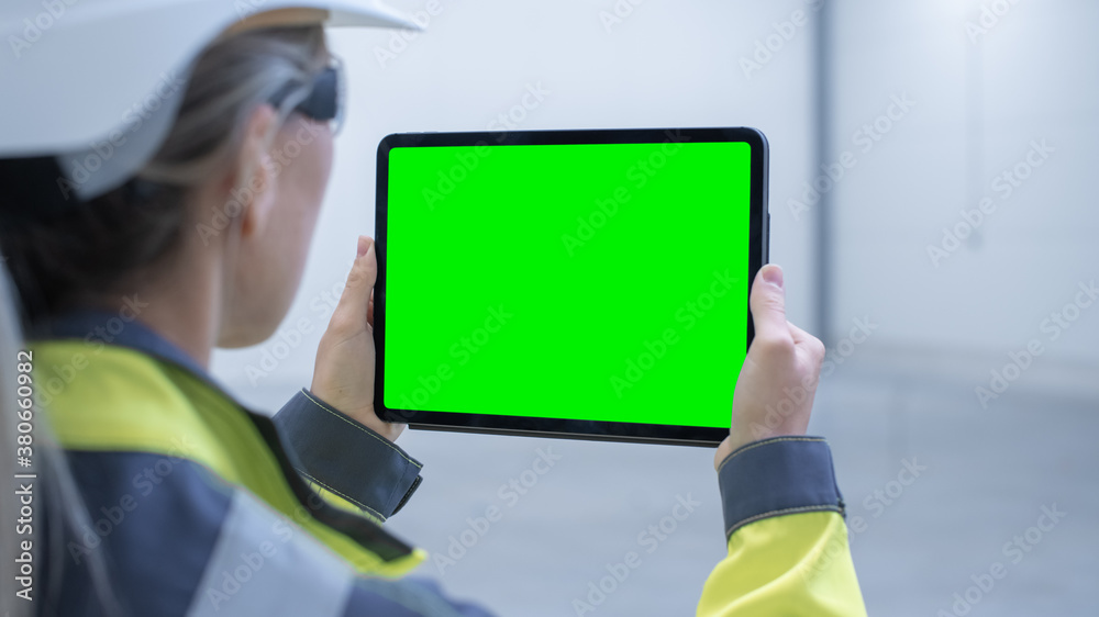 Industry 4.0 Modern Factory: Female Engineer Uses Digital Tablet Computer with Green Screen Mock-up 