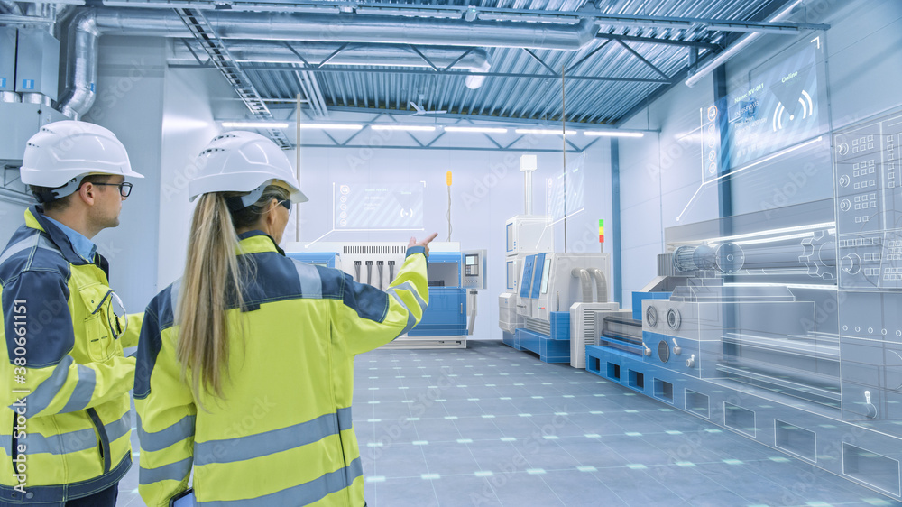 Two Engineers Standing and Talking in Factory Workshop with Augmented Reality 3D Models CNC Machiner