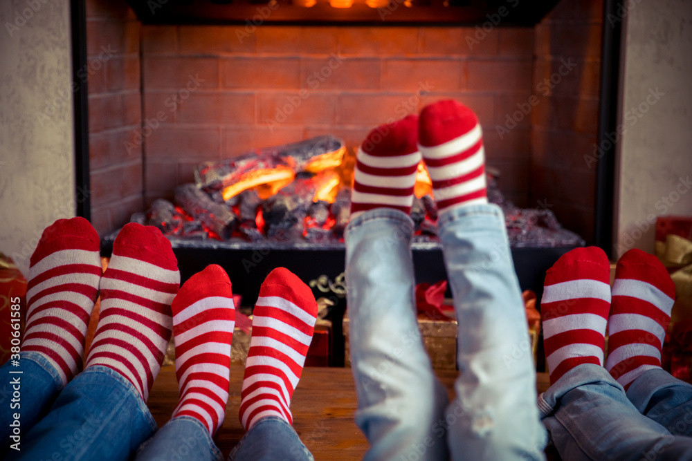 Happy family with children near fireplace at Christmas