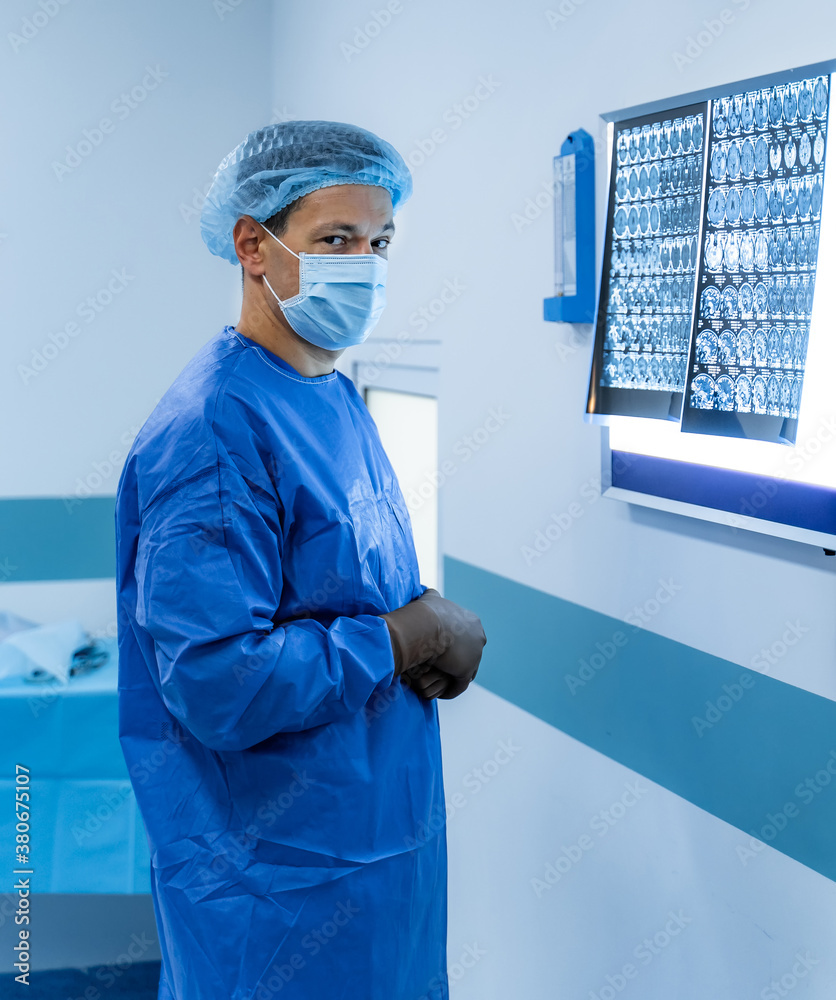 Doctor explaining an x-ray image near the white enlighted board. Magnetic resonance imaging film. Me