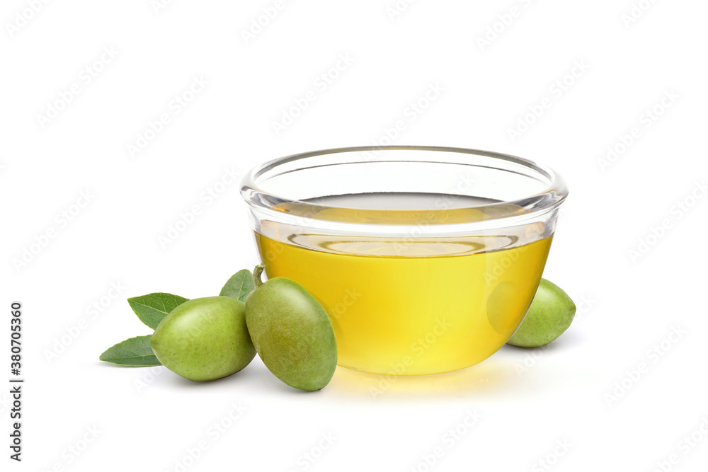 Glass bowl of  Virgin olive oil with olives and leaves isolated on white background.