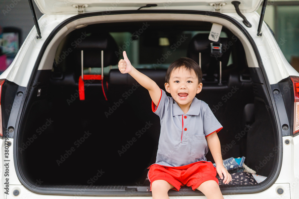 Back to School Concept.Happy Funny little asian boy raising hands thumb up and very excited and glad