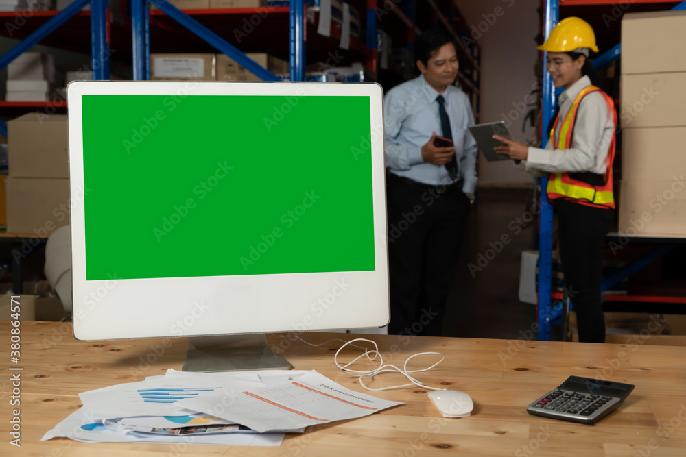 Computer with green screen display in warehouse storage room . Delivery and transportation software 