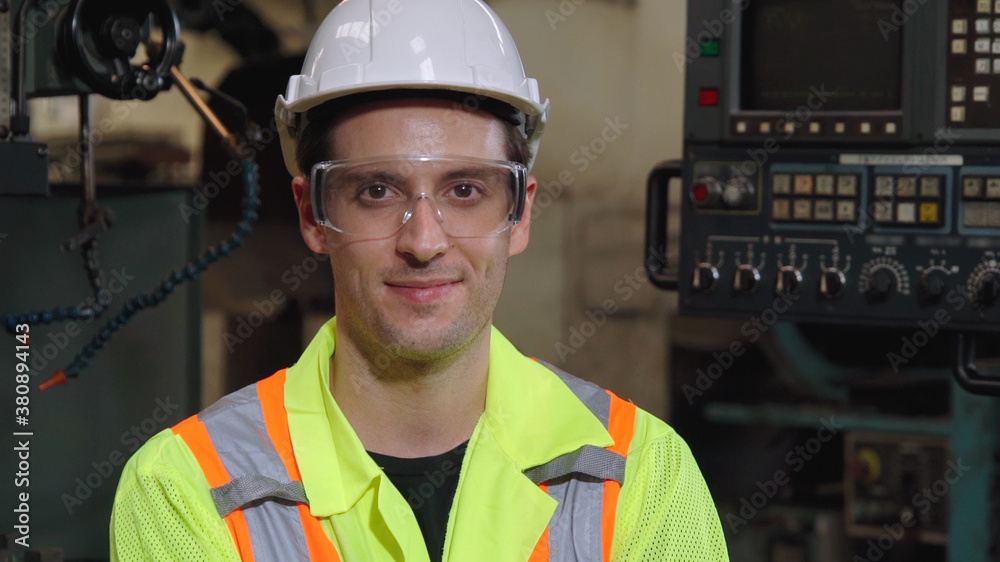 Young factory worker or engineer close up portrait in factory . Industry and engineering concept .