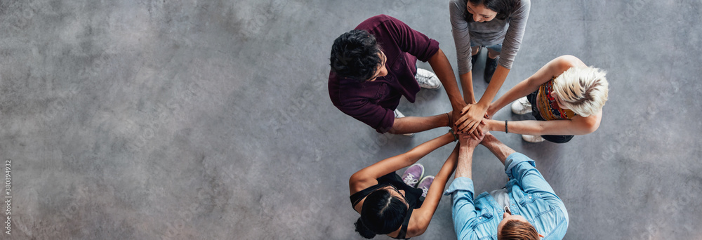 Students making a stack of hands