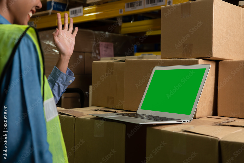 Computer with green screen display in warehouse storage room . Delivery and transportation software 