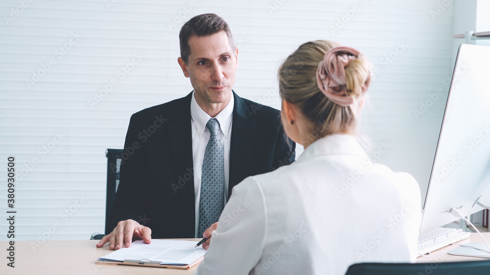 Job seeker in job interview meeting with manager and interviewer at corporate office. The young inte