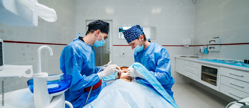 Two dentists examine patients teeth. Modern stomatology cabinet. Dentistry, medicine, medical equip