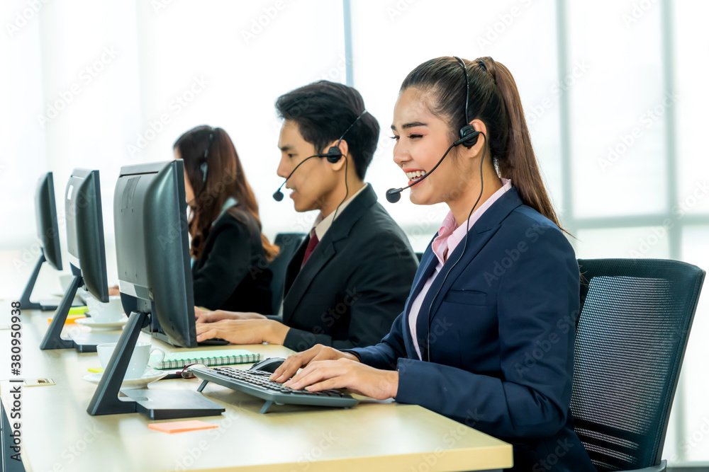 Business people wearing headset working in office to support remote customer or colleague. Call cent