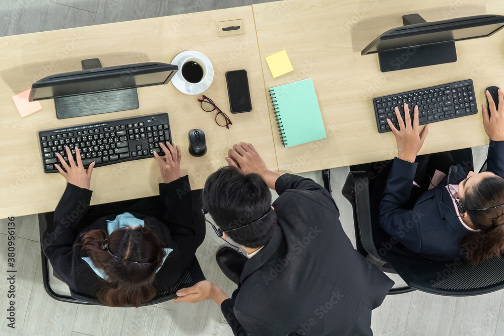 Business people wearing headset from top view in office working with computer to support remote cust