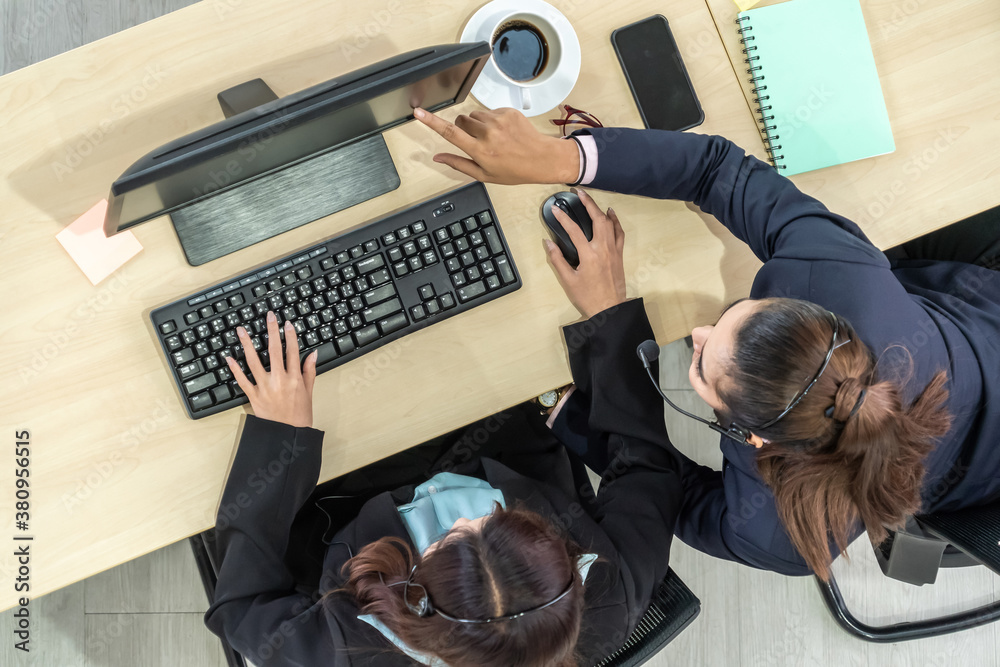 Business people wearing headset from top view in office working with computer to support remote cust