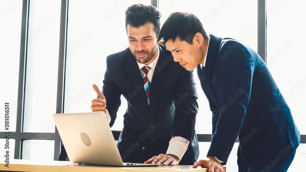 Two business people talk project strategy at office meeting room. Businessman discuss project planni