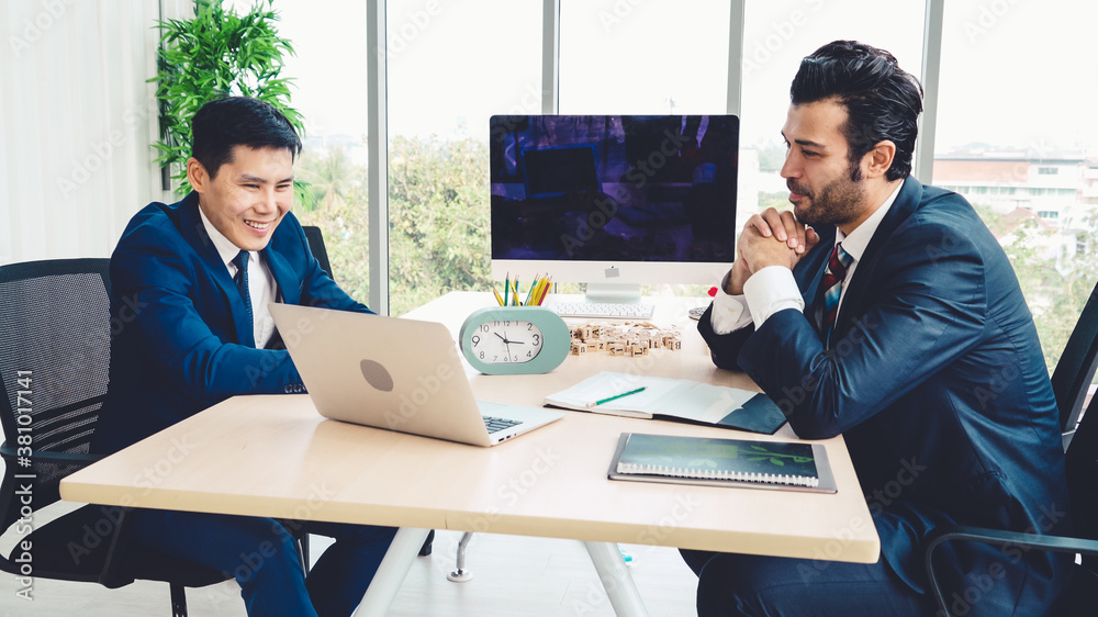 Two business people talk project strategy at office meeting room. Businessman discuss project planni