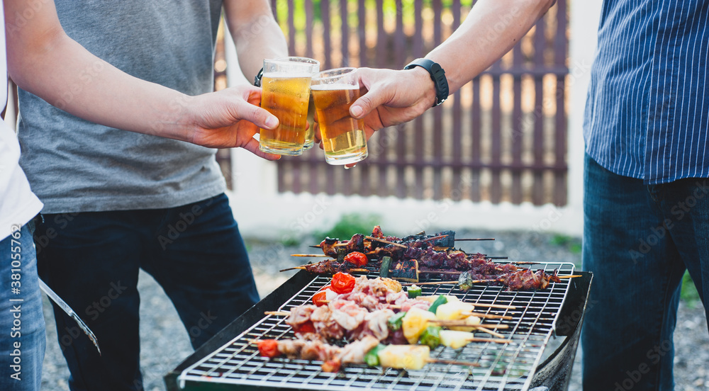 Outdoor party with friends in the backyard with BBQ and beer.