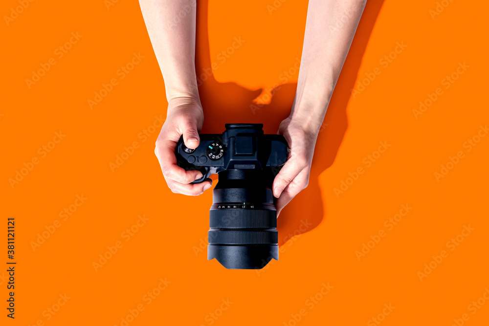 Person holding a SLR camera from above