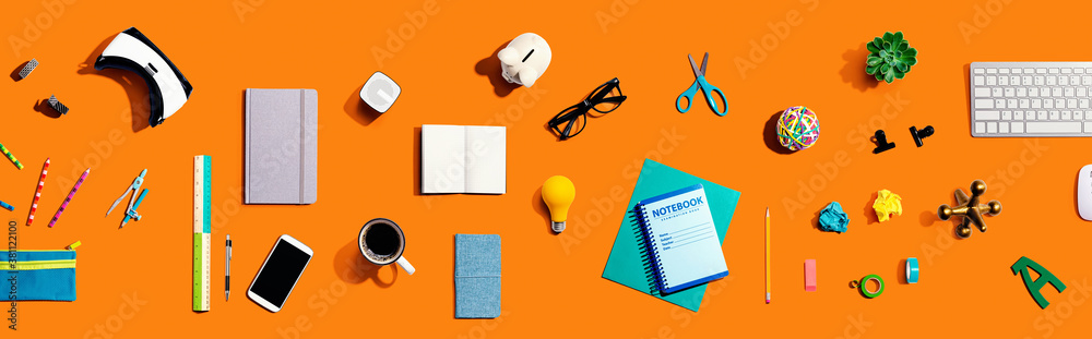 Collection of electronic gadgets and office supplies - flat lay