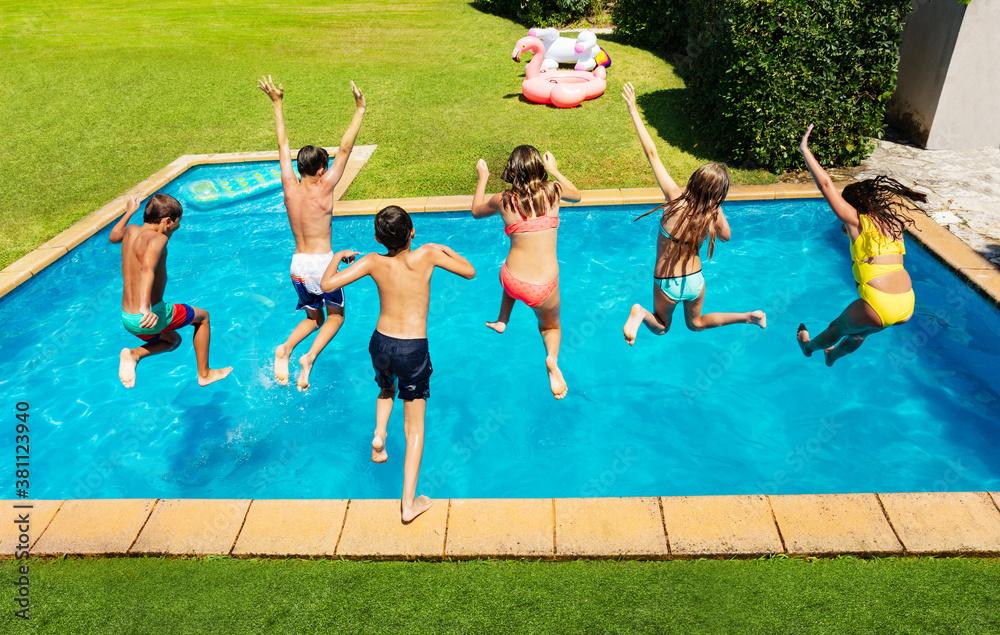 Many cute children jump into the swimming pool about to dive view from above