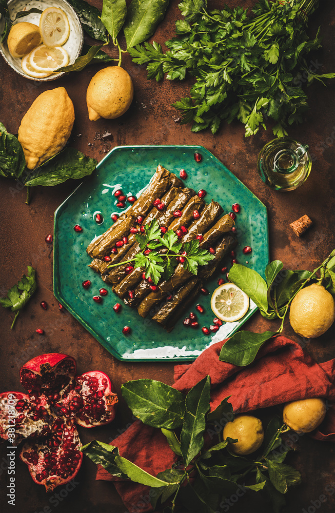 Turkish traditional starter meze. Flat-lay of Sarma wine leaves filled with rice, spices with pomegr