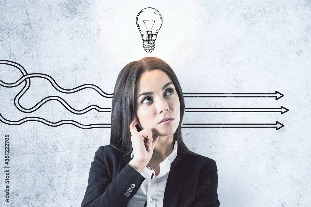 Thinking businesswoman in suit and drawing arrows with light bulb