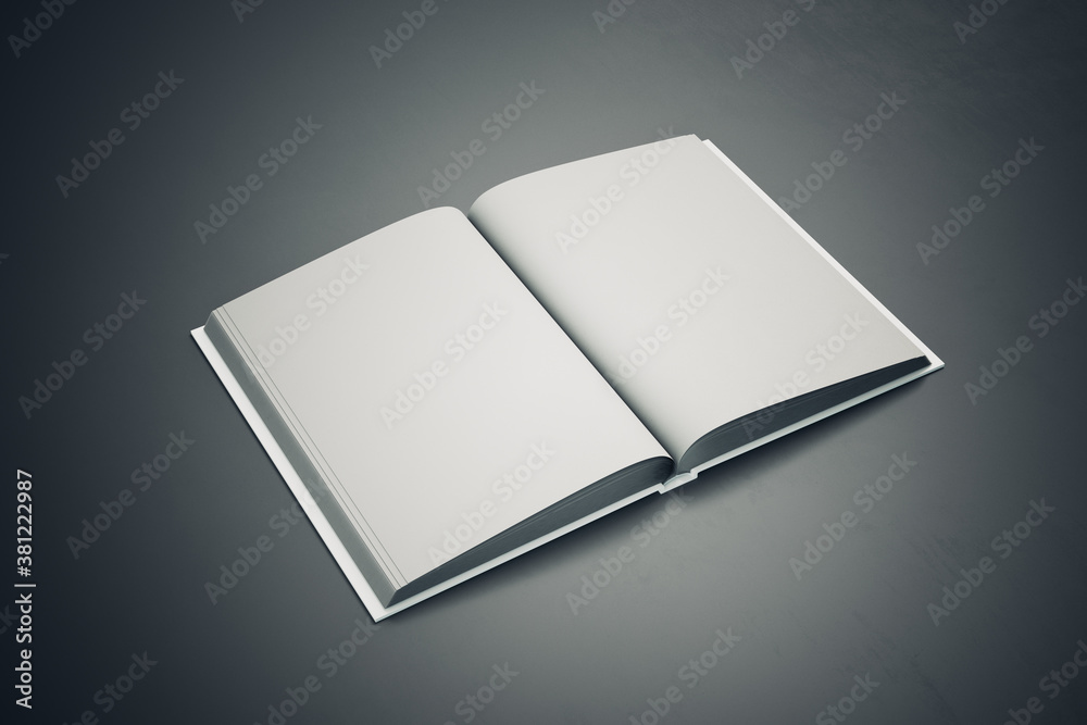 Top view of open white book on gray table.