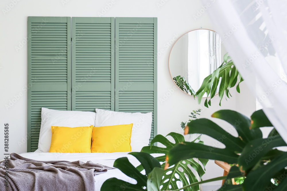 Interior of modern stylish bedroom with mirror