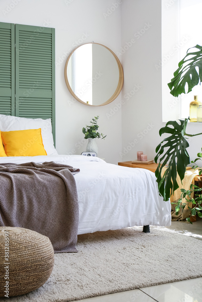 Interior of modern stylish bedroom with mirror