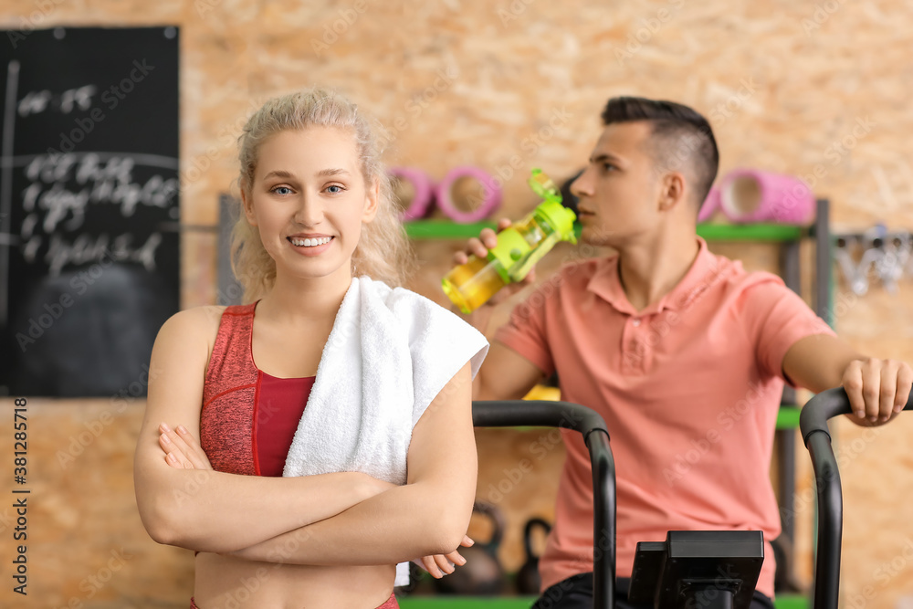 Young sporty woman training in gym