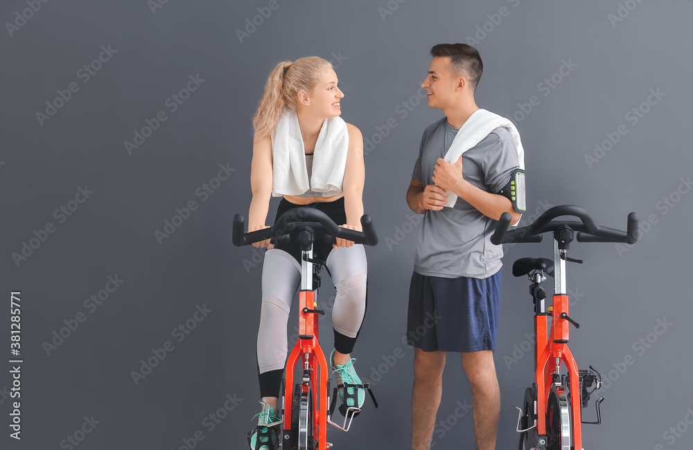 Young people training on exercising bike in gym